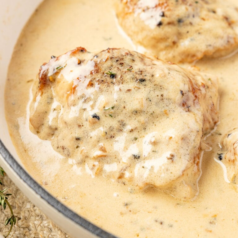 Close up of Chicken Au Poivre in a skillet with cream sauce.