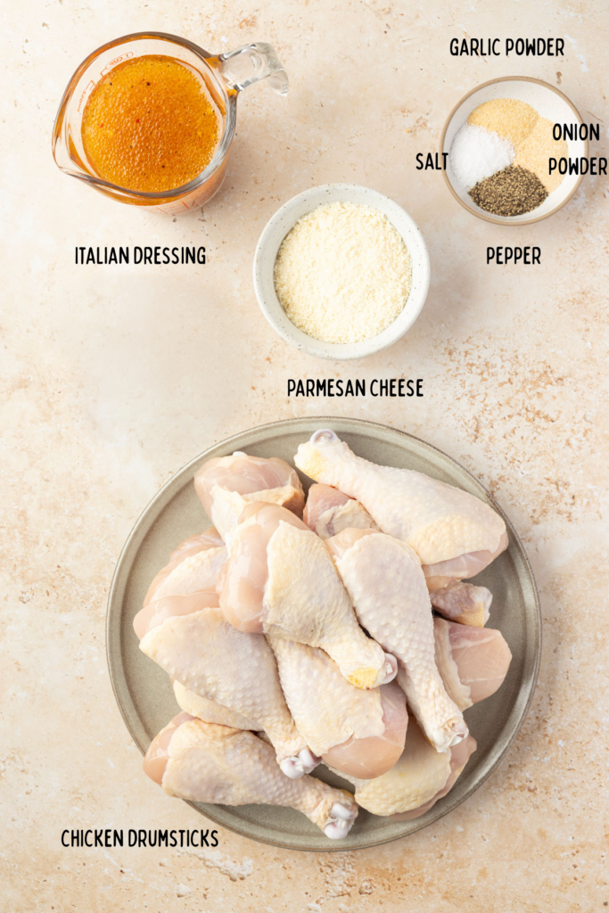 Ingredients for self cooker, drumsticks in individual mixing bowls, measuring cups, and a plate.