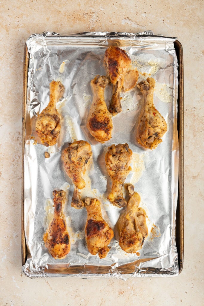 Finish broiled chicken drumsticks on a sheet pan lined with aluminum foil.