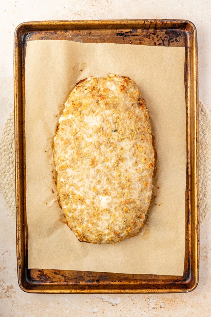 Cooked turkey meatloaf on a sheet pan without any glaze.