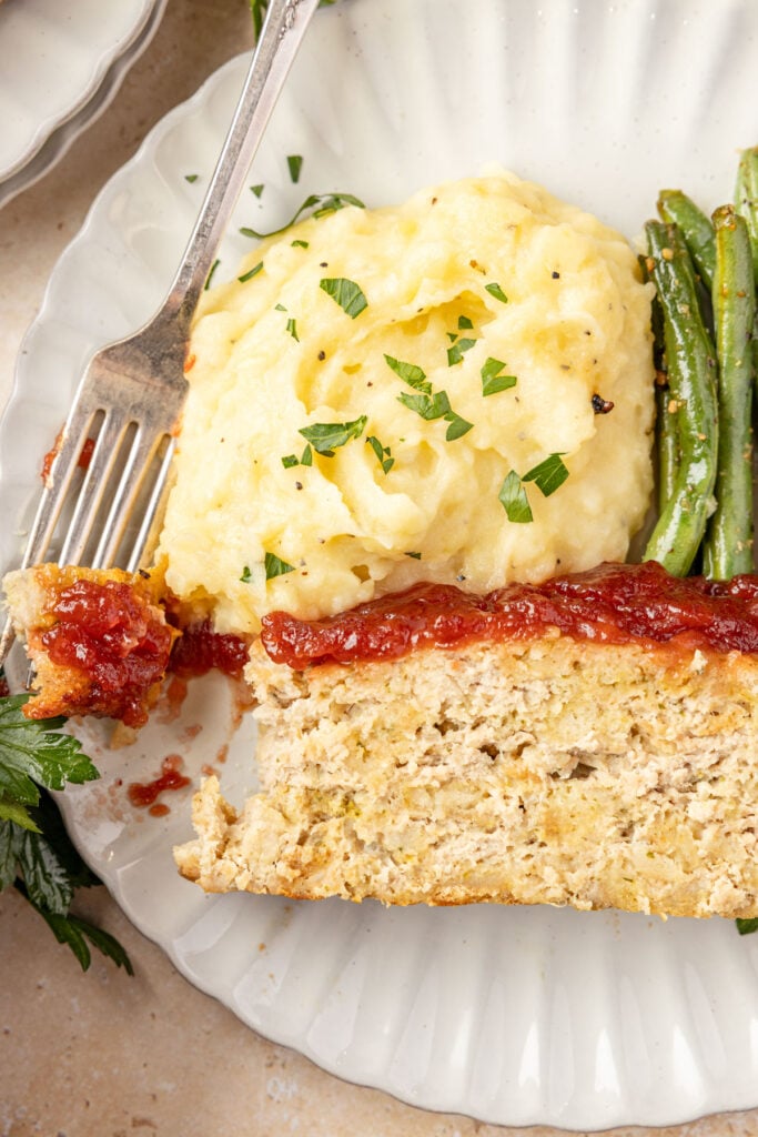 Thanksgiving Meatloaf on a plate with mashed potatoes and green beans.