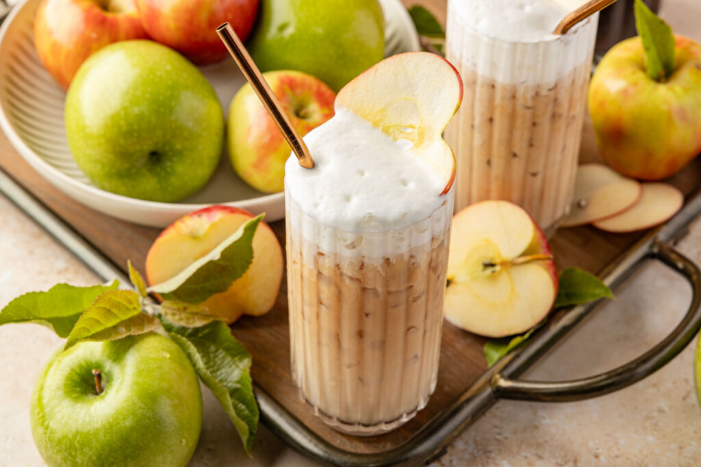Apple Chai Latte on a tray with apples and leaves around it