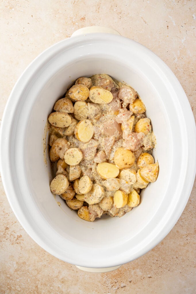 chicken, potatoes, sauce and spices in a slow cooker